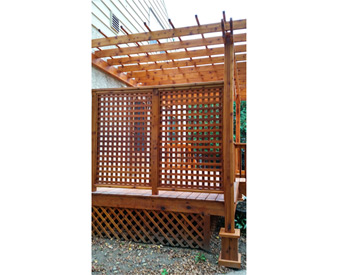 10 x 16 Cedar 2-Beam Wall Mount Pergola shown with cedar stain, lattice wall, 16" top runner spacing, and no deck. 