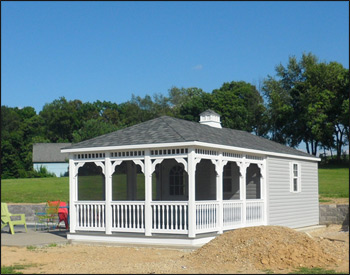 12 x 20 Vinyl Pool House shown in White Vinyl Siding with 30 Year Architectural Oxford Gray Asphalt Shingles, Gray Composite Deck, Shutters, Full Set of Screens, Cupola and Screened Door. 