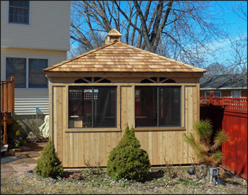 12 x 16 Cedar Rectangle Cabana shown with No Floor, Standard Single Door, No Shutters, No finished Interior, No Finished Ceiling, Cedar Shake Shingles, Cupola, Dome Skylight, and Sunburst Design Walls. 