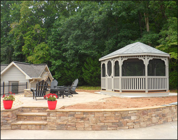 12 x 16 Treated Pine Oval Gazebo shown with treated pine deck, 1x3 standard railings, standard braces, straight fascia, no cupola, full set of screens and screen door, treated pine tongue and groove ceiling, Old English Pewter asphalt shingles, River Birch stain, stainless steel hardware, screened floor, and Hidden Wiring w/ 1 Receptacle & Switch.