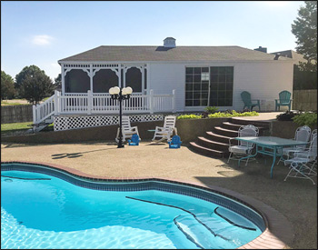 22 Enclosed, 14 Porch White Vinyl Pool house shown with Vinyl Siding and Black Trim, Gray Composite Deck, Standard Railings, One 18" x 36" Window, One 24" x 36" Window, Customers Sliding Glass Door, Single Door from Enclosure to Deck, Screen with Screen Doors, Customer Supplied Shingles, Solid Wall on back of Porch with Vinyl Siding on Both Sides and Finished Ceiling, 8x8 Floor Cutout for Customer Hot Tub, and Cupola.