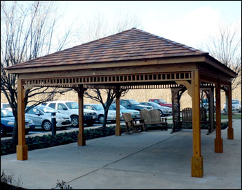 16 x 20 Treated Pine Rectangular Gazebo shown with no railings, 6 posts, laminated header beams, cedar shake shingles, 6:12 pitch roof, and 2 coats of cedar stain sealer.