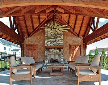 30 x 30 Custom Grand Bay Ramada with additional roof sections below the gables, Slate Gray Asphalt Shingles, Cedar Stain, and a substantial amount of stonework done by the customer with a 3rd party.