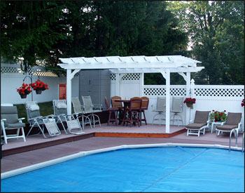 2 Beam Vinyl Pergola Shown. Custom size and shape: 11 11" x 8 6" x 12 6" x 12, 2x8 Header Beams, 2x6 Decorative Scroll Ends., Straight Cut Runners, 1x1 Top Runners 12" on Center, and Gray Composite Deck