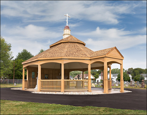 Custom 30 Treated Pine Oval Double Roof Gazebo shown with 42" Tall Railings with 3 Additional Openings, 10" Tall Posts, Arched Beams, Vinyl Finished Ceiling, Harvest Gold Asphalt Shingles, 8/12 Pitch Roof, 3 Full Wall Privacy Walls, Custom Portico, and Custom Fiberglass Cupola.