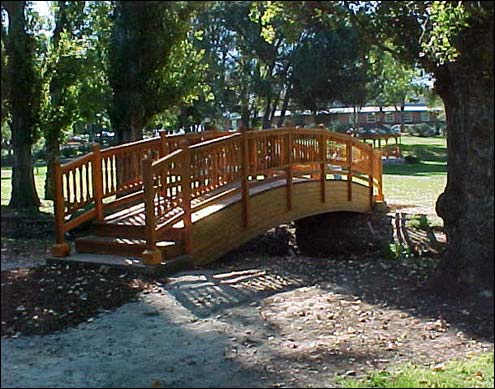 5 x 26 Custom Heavy Duty Bridge, (treated Pine glue lam Beams, cedar decking and turned spindle railings, custom steps and cedar tone stain sealer.